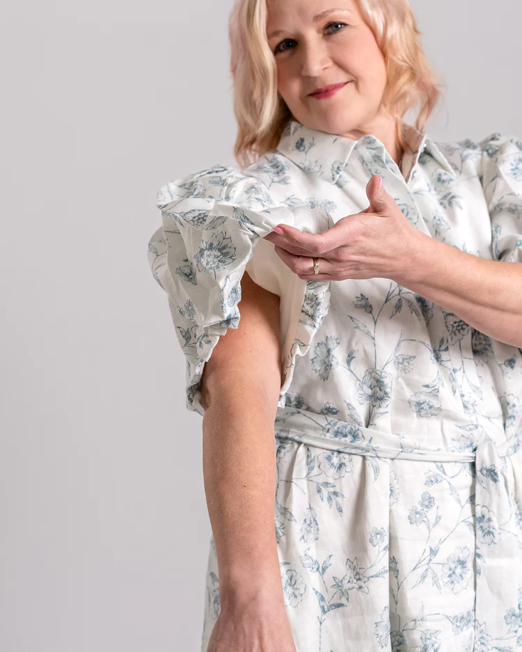 Woman wears summer short dress with billowing sleeves